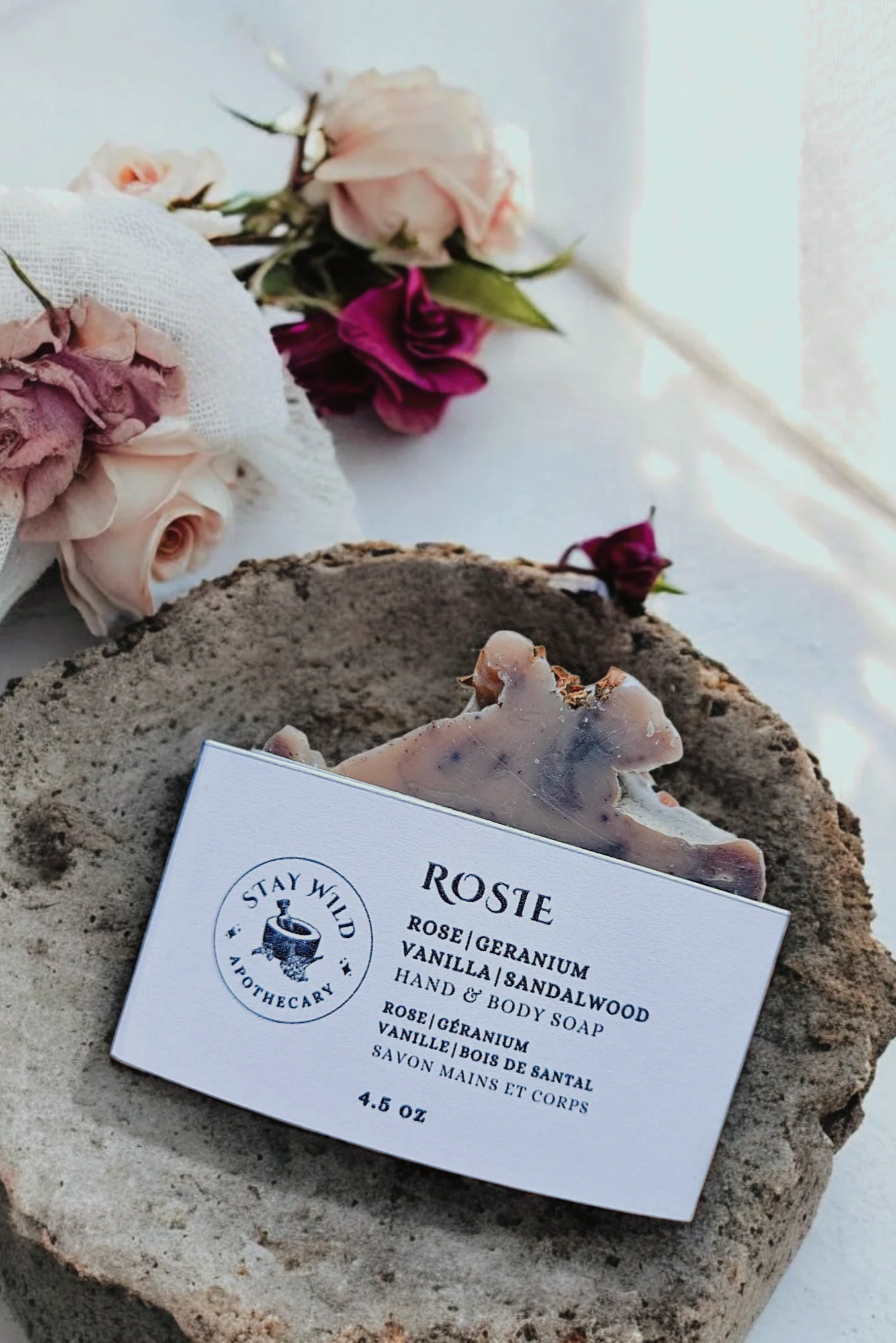 The Rosie Soap by Stay Wild Apothecary is shown in a stone dish.