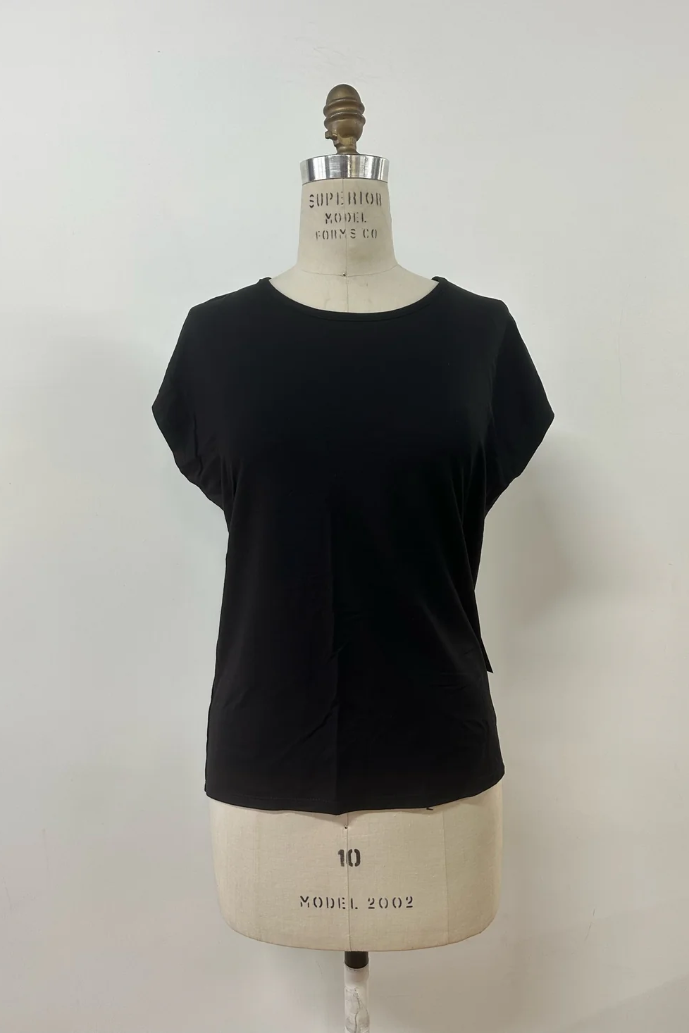 The Eowyn T-Shirt by Kollontai in Black is shown on a white mannequin against a white background.
