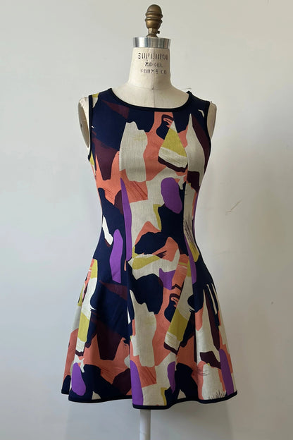 The Silba 2026 Dress by Kollontai, a sleeveless short dress in a Multicolour abstract print with a fit and flare shape and princess seams, is shown on a mannequin against a white background. 