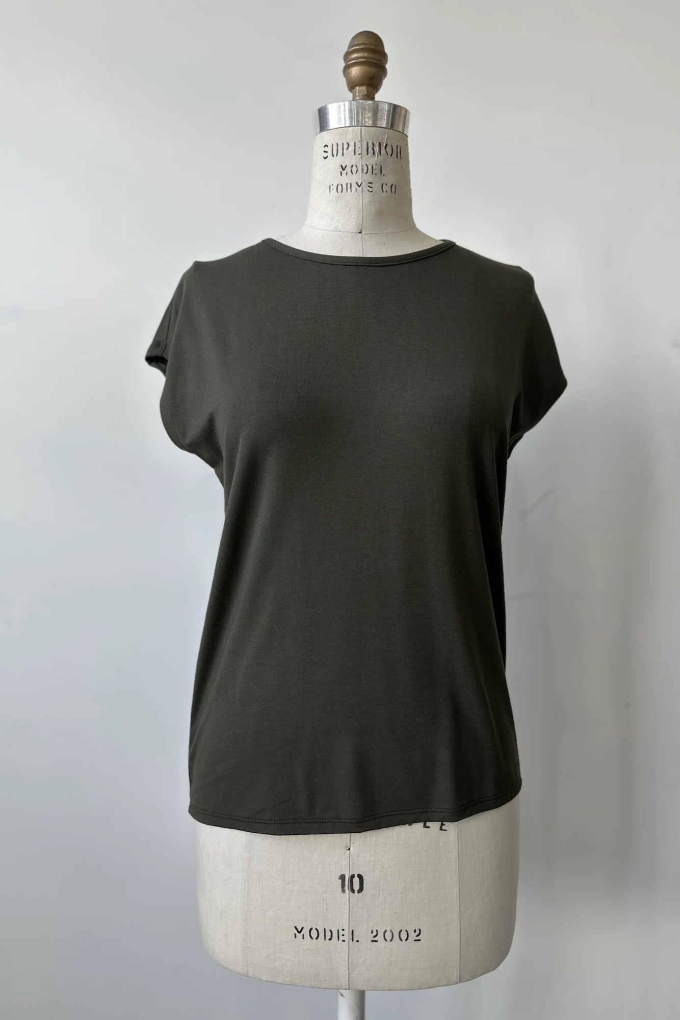 The Eowyn T-Shirt by Kollontai in Fir is shown on a white mannequin against a white background.