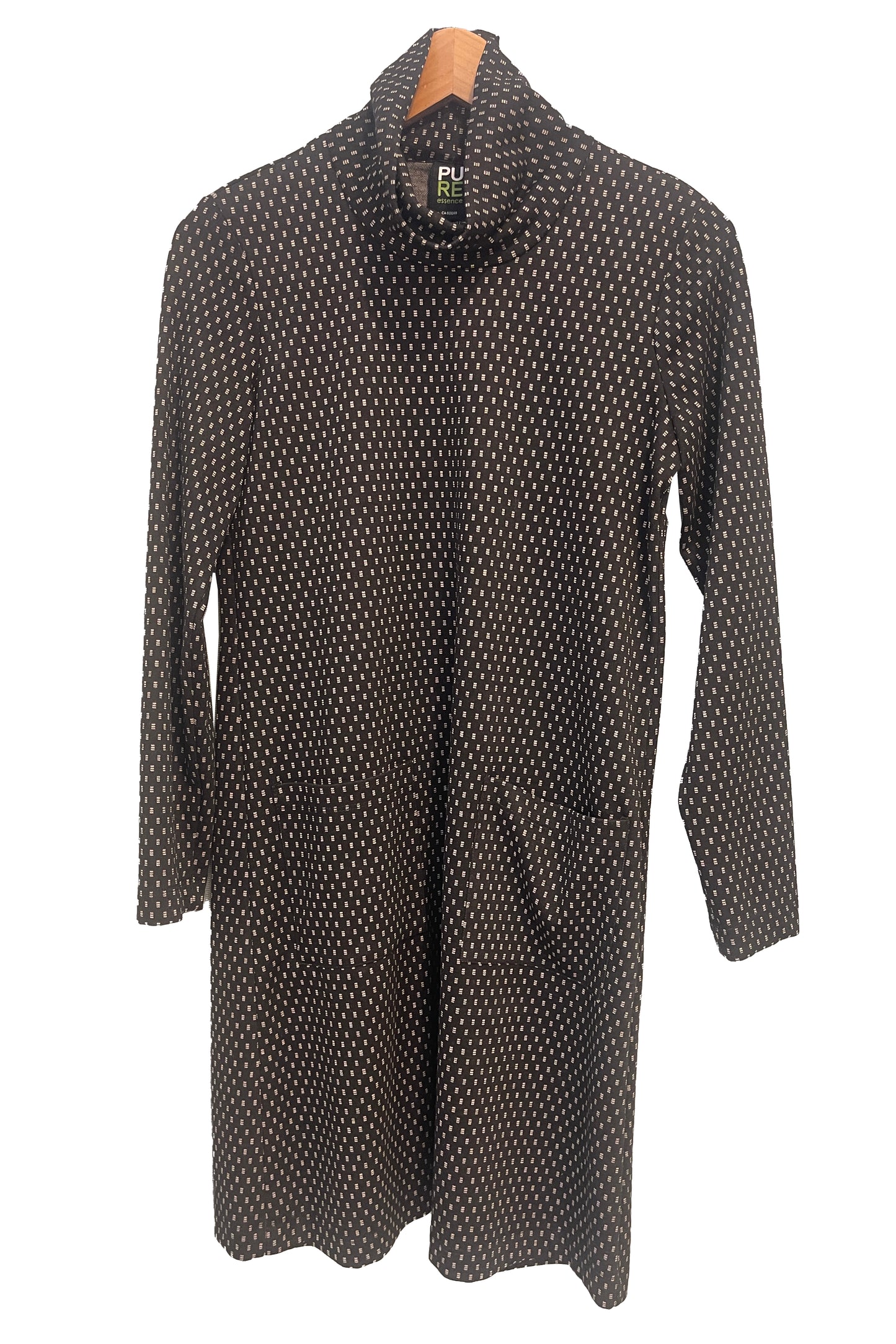 The Floella Dress by Pure Essence in Black/Ivory/ featuring a turtleneck, long sleeves, a slight a-line shape that hits the knee, and front patch pockets, is shown hanging against a white background. 
