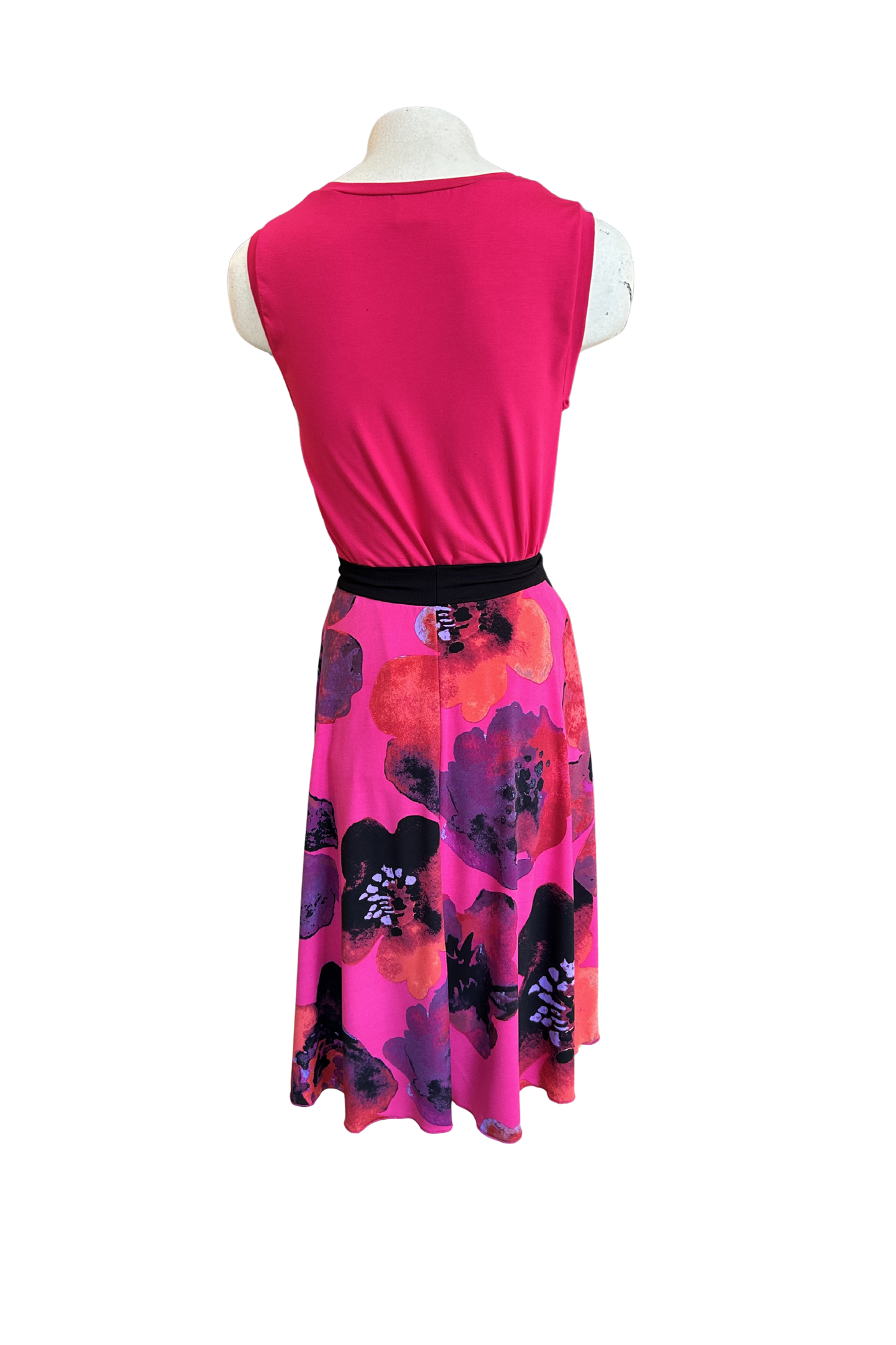 A back view of the Folie Skirt in Fuchsia Print by Slak is shown on a mannequin with the Neon Camisole in Fuchsia against a white background. It's a below-the-knee A-line skirt with a contrast pull-on waistband. 