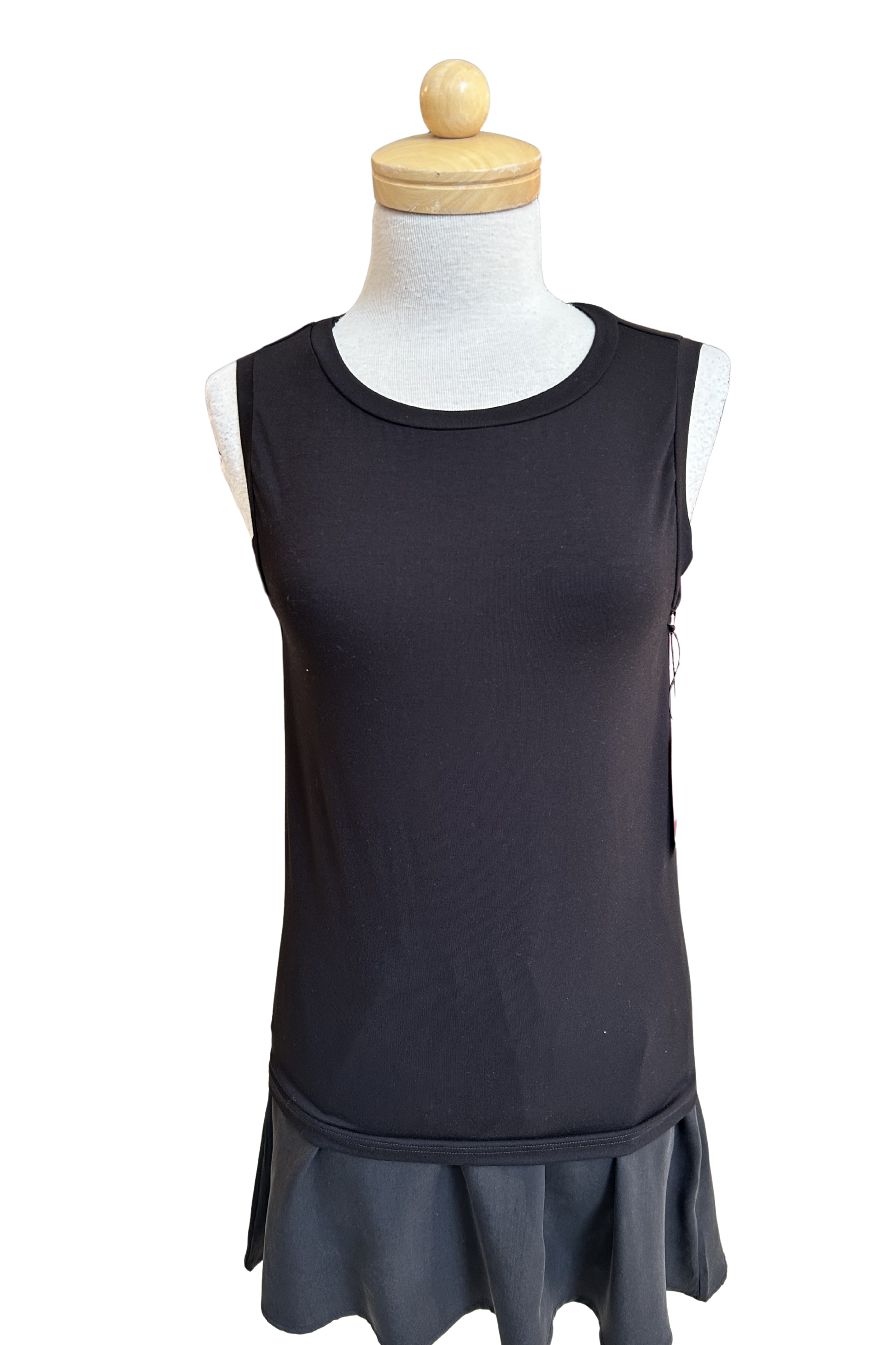 The Neon Camisole by Slak in Black, a high necked, wide strapped tank, is shown on a mannequin with a black skirt against a white background.