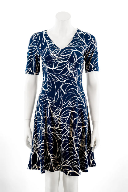 The Liana Dress by Karkass in Navy and white print, an above the knee dress with short sleeves, a V-neck and princess seams, is show on a mannequin against a white background. 