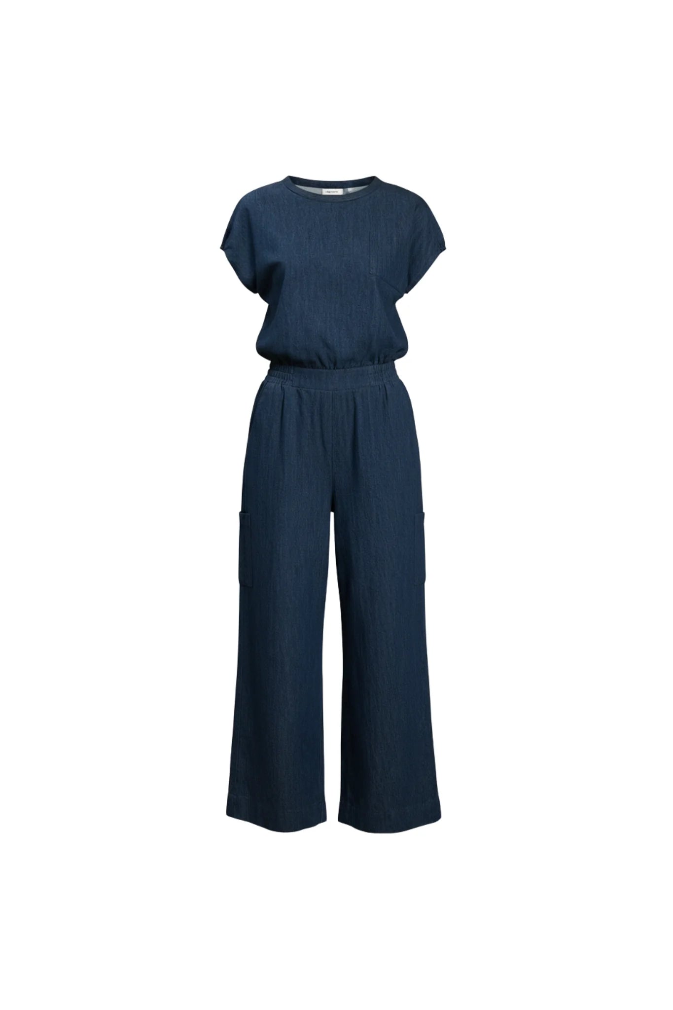 The Michele Jumpsuit by Melow in Denim, with short extended sleeves with gathered cuffs, a defined waist with elastic at the back and sides, an invisible back zip, a chest pocket, and wide full-length legs, is shown against a white background. 