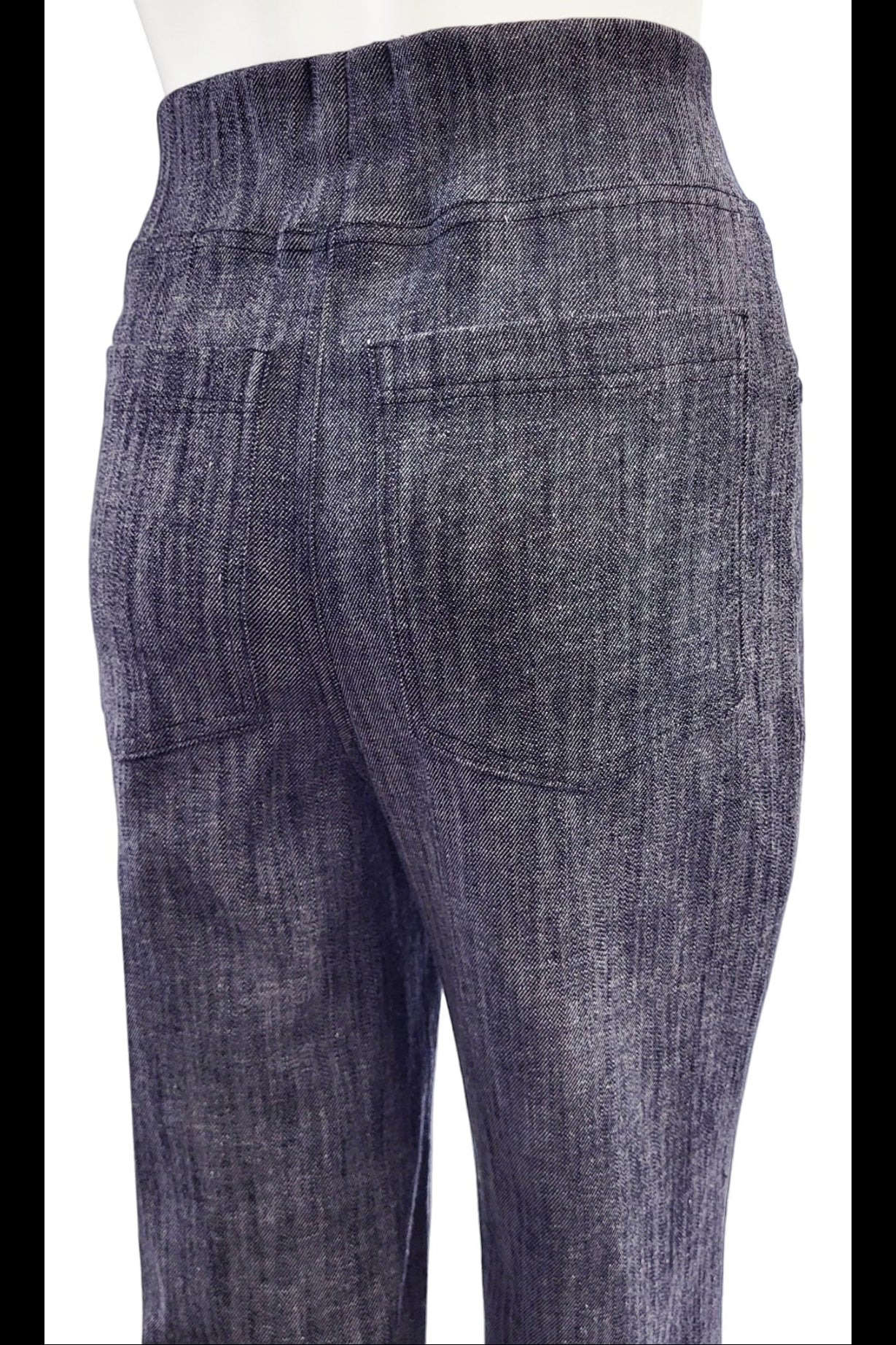 Close up back view of the The Wade Vintage Denim Pants in Indigo by Mandala are shown on a mannequin against a white background.
