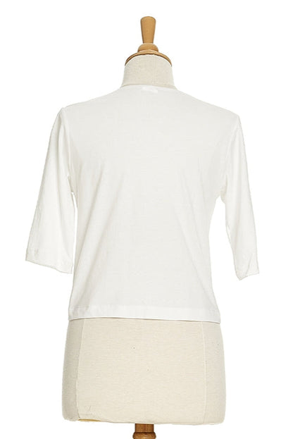 A back view of the Salvador Bolero in White from Rien ne se Perd, featuring 3/4 sleeves and an angled hem, is shown on a mannequin in front of a white background. 