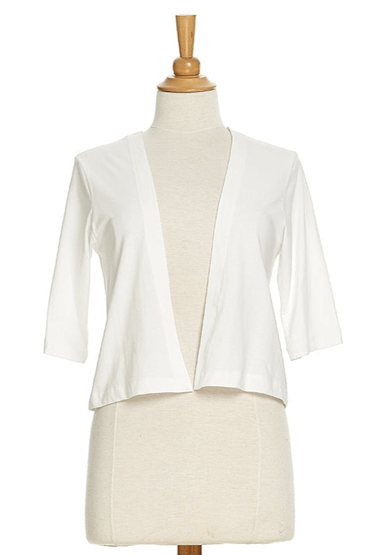 The Salvador Bolero in White from Rien ne se Perd, featuring 3/4 sleeves and an angled hem, is shown on a mannequin in front of a white background. 