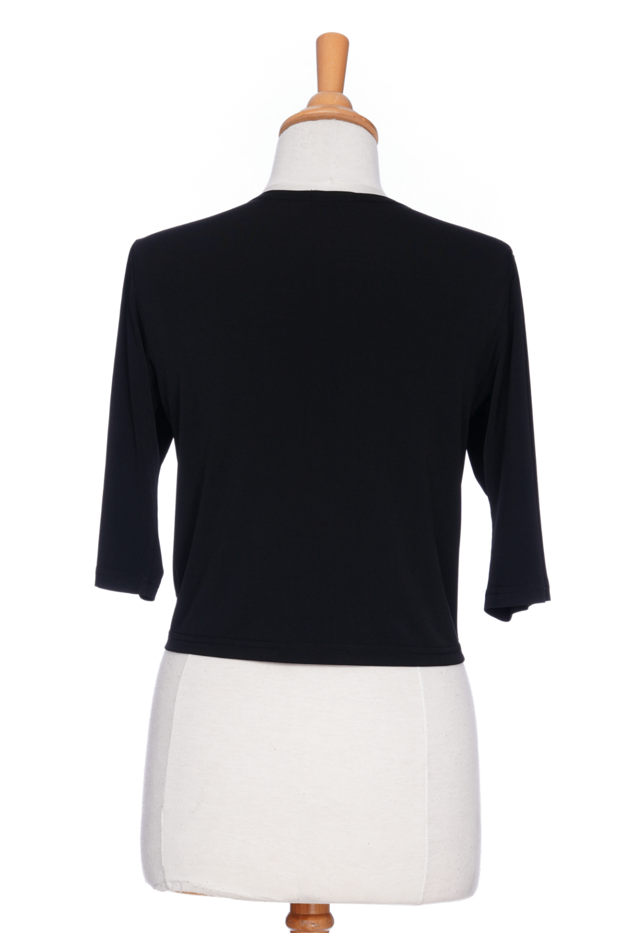 A back view of the Petillant Bolero by Rien ne se Perd in Black, with 3/4 sleeves and a tie front, is shown on a mannequin against a white background. 